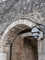 Ohrid lamp against the background of the stone gate of the old town.