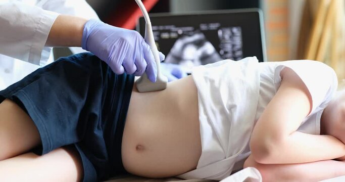 Diagnosis of lower back and kidneys in girl using ultrasound. Medical examination of the internal organs of child concept