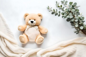 Toy teddy bear and eucalyptus branch on white ivory blanket throw background. Blank infant onesie mockup template. Top view