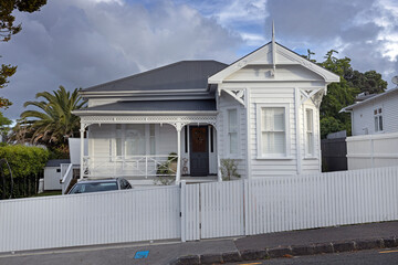 Wooden victorian house Ponsonby Auckland New Zealand. White fence and porch.