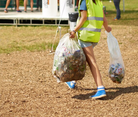 Woman, cleaning and event outdoor garbage for recycle cans at festival for sustainable eco friendly, nature environment on campground. Female person, plastic bag at social party, helping in forest - obrazy, fototapety, plakaty