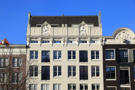 Amsterdam Oude Schans White Building Facade with Sculpted Decoration Depicting Dogs, Netherlands