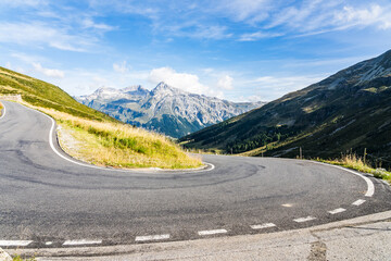 Road with hairpin curve in the Swiss Alps on a sunny day