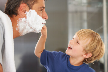 Help with shaving, dad and child with cream on face, smile and bonding in home with morning routine. Teaching, learning and father with happy son in bathroom for shave, clean fun or grooming together - obrazy, fototapety, plakaty