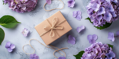 Gift box and purple fresh flowers on light background. Banner