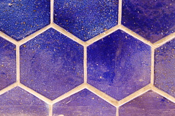 Close-up of old hexagonal wall tiles.