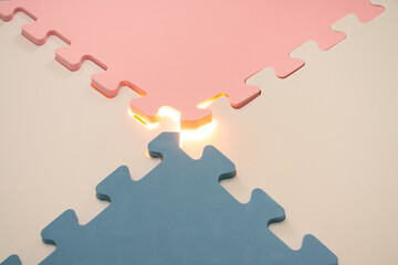 Concept for teamwork, problem solving or mystery stuff. Jigsaw puzzle with a glowing light. After...