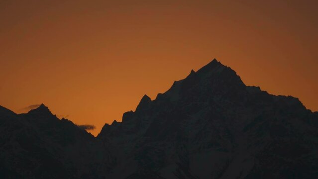 Silhouette shot of snow covered Kinnaur Kailash mountain during the sunrise in winter as seen from Kalpa in Kinnaur, Himachal Pradesh, India. View of Holy Kinnaur Kailash mountain range in morning.	