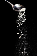 Flour fall down in air. Black background Isolated, selective focus