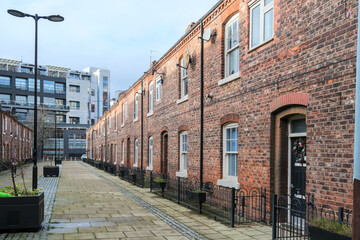 Anita street in Ancoats district, with its brick wall houses in a row, Manchester