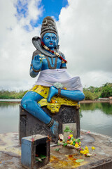 Hindu Statue Seated Atop Cement Block