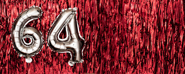 Silver foil balloon number, digit sixty-four on red background. Birthday greeting card with...