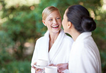 Spa, friends and happy women drinking coffee for health, wellness and skincare treatment. Girls, tea cup and salon for beauty, luxury body therapy in bathrobe and diverse people laughing in nature - obrazy, fototapety, plakaty