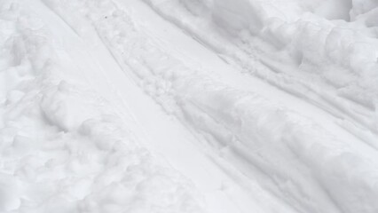 Close-up of ski tracks in the snow. Background on the theme of winter sports.