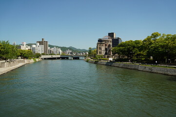 Fototapeta na wymiar The Atomic Bomb Dome is located beside the Motoyasu River in Hiroshima, Japan.