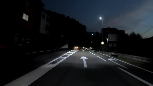driving a car on countryside road at night with adaptive matrix headlights