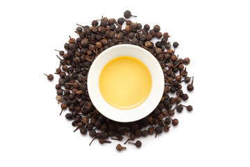 Top view of Dry organic Sheetal Chini (Piper cubeba) seeds, along with its essential oil.