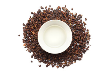 Top view of Dry organic Tomar Seeds (Zanthoxylum armatum), along with its essential oil.