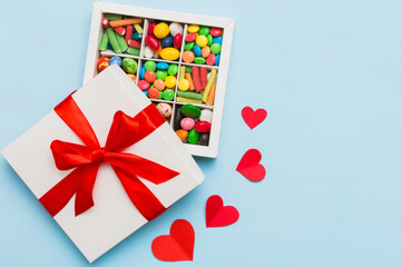 Valentine day composition: sweet candy, with gift boxes with bow and red felt hearts, photo template, background. Top View with copy space