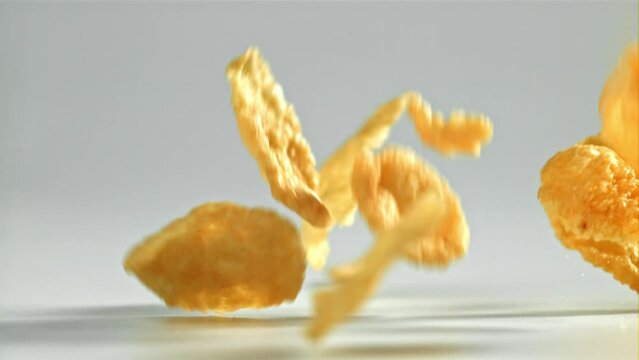 Corn flakes falling on white background. Filmed on a high-speed camera at 1000 fps. High quality FullHD footage
