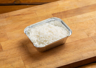 Boiled rice on a wooden board