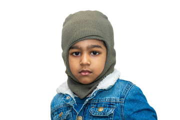 Asian boy wearing jeans jackets and monkey caps. A fashionable boy in heavy winter clothes looking at the camera.