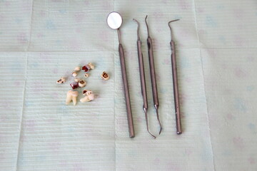 Dental instruments and extracted teeth on a napkin