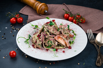 Georgian food salad with cucumbers, cherry tomatoes, onion, pomegranate seeds and herbs in walnut dressing.
