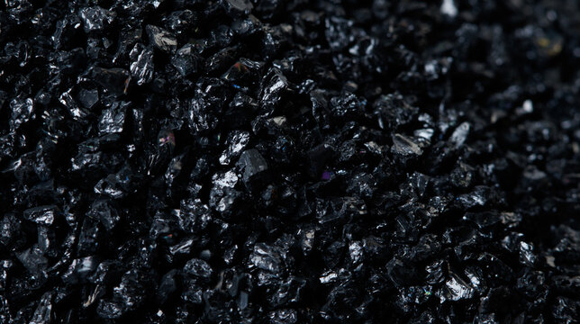 Macro close up of Silicon Carbide black sand size. Fine particle silicon carbide pile up, White background Isolated, particle element object