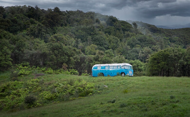 Abandoned blue oldtimer bus on the hills. Pukeinoi. Coast West New Zealand.