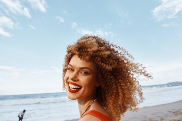 Beach Lifestyle: A Happy Woman with a Smiling Face and Curly Hair, Backpacking for a Vacation Trip,...