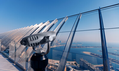 Binoculars for city viewing skyview, Observation deck in marina island in Dubai and modern...