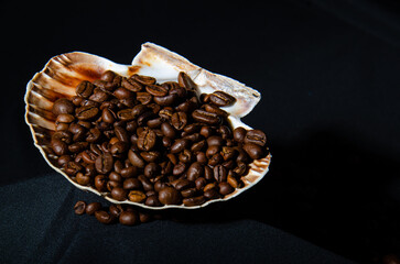 Coffee beans beautifully scattered on a black background