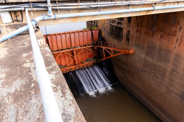water gate close with water flowing in dam water management irrigation concept.