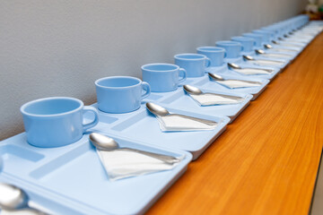 Coffee cups with spoon prepared for coffee break for participant at a meeting or seminar audience meeting room.