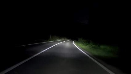 driving a car on countryside road at night with adaptive matrix headlights