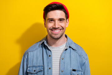 Photo of good mood cheerful man dressed jeans shirt smiling showing white teeth isolated yellow color background