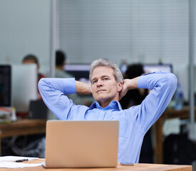 Mature, businessman and thinking by laptop at desk, planning and professional for technology in agency. HR, manager and idea by computer for connectivity in office, network and relax in workplace