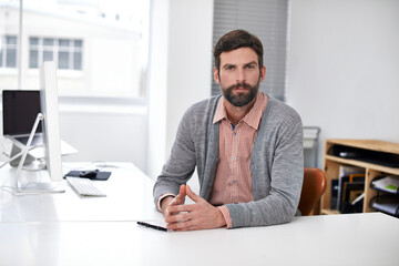 Businessman, portrait or serious at desk in modern office, professional or career pride in company....