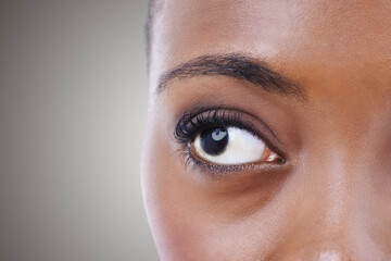 Half, face and eye of woman with vision for contact lenses and healthcare in studio background...