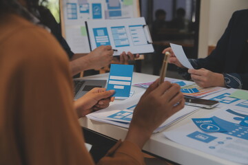 Close up ux developer and ui designer use augmented reality brainstorming about mobile app interface wireframe design on desk at modern office.Creative digital development agency