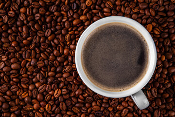 Black espresso coffee cup with croissant and coffee beans, simple traditional french breakfast 