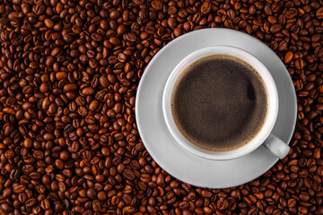 Black espresso coffee cup with croissant and coffee beans, simple traditional french breakfast 