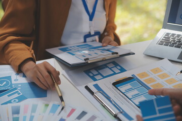 Close up ux developer and ui designer use augmented reality brainstorming about mobile app interface wireframe design on desk at modern office.Creative digital development agency