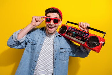 Photo of good mood excited man dressed jeans shirt dark spectacles listening boom box songs...