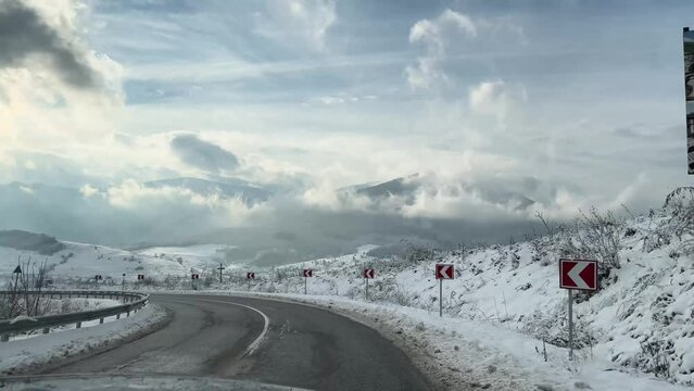 Ukraine, Carpathians, winter snowy Transcarpathia, car speed on mountain turns as a symbol of danger and sporty driving