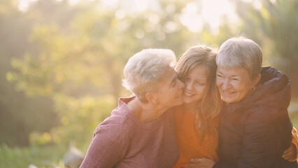 A Senior gay lesbian couple or family is kissing, hugging and enjoying their a good memorable time...