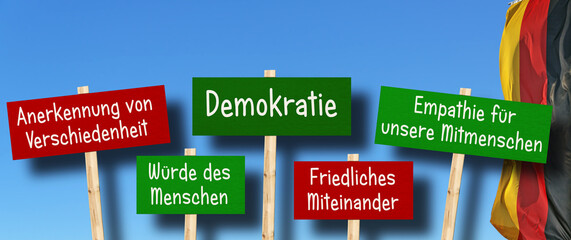 Demokratieschilder mit deutscher Flagge im Hintergrund - obrazy, fototapety, plakaty