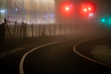 Stockholm, Sweden Train or tram tracks at night and traffic signals in the Liljeholmen district.