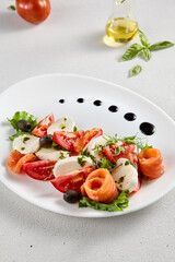 Salmon and mozzarella Caprese salad with fresh tomatoes, top view. Ideal for culinary magazines and healthy eating blogs